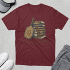 Maroon t-shirt with a stack of books featuring pickleball puns and a pickleball paddle.