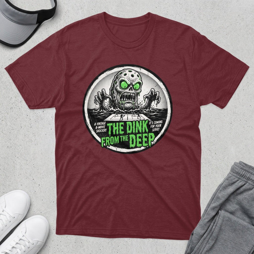 T-shirt featuring a vintage horror graphic with text: "The Dink From The Deep".