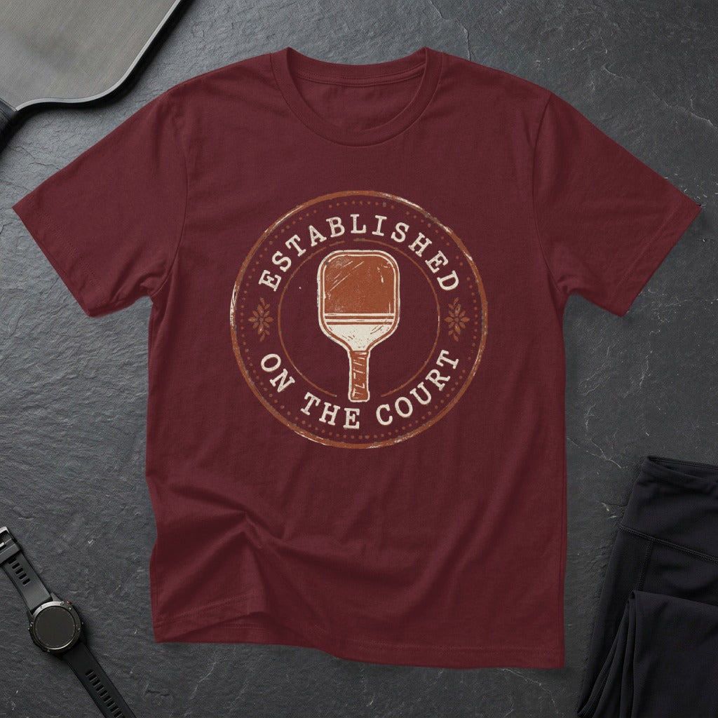 Maroon t-shirt with "Established on the Court" and pickleball paddle graphic.