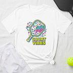 White t-shirt with "COURT VIBES" and a colorful pickleball paddle graphic.