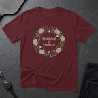 Maroon t-shirt with a floral pickleball paddle wreath and text.