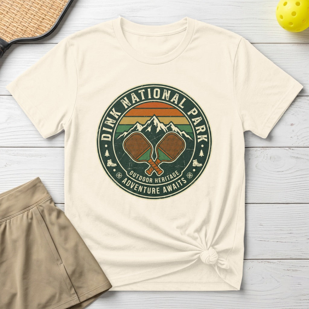 Dink National Park circular logo with pickleball paddles and mountains.
