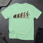 T-shirt with cartoon evolution of man holding a pickleball paddle.