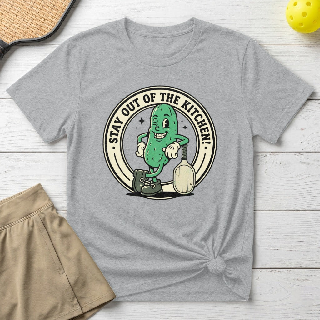 T-shirt with cartoon pickle holding paddle, text "STAY OUT OF THE KITCHEN!".