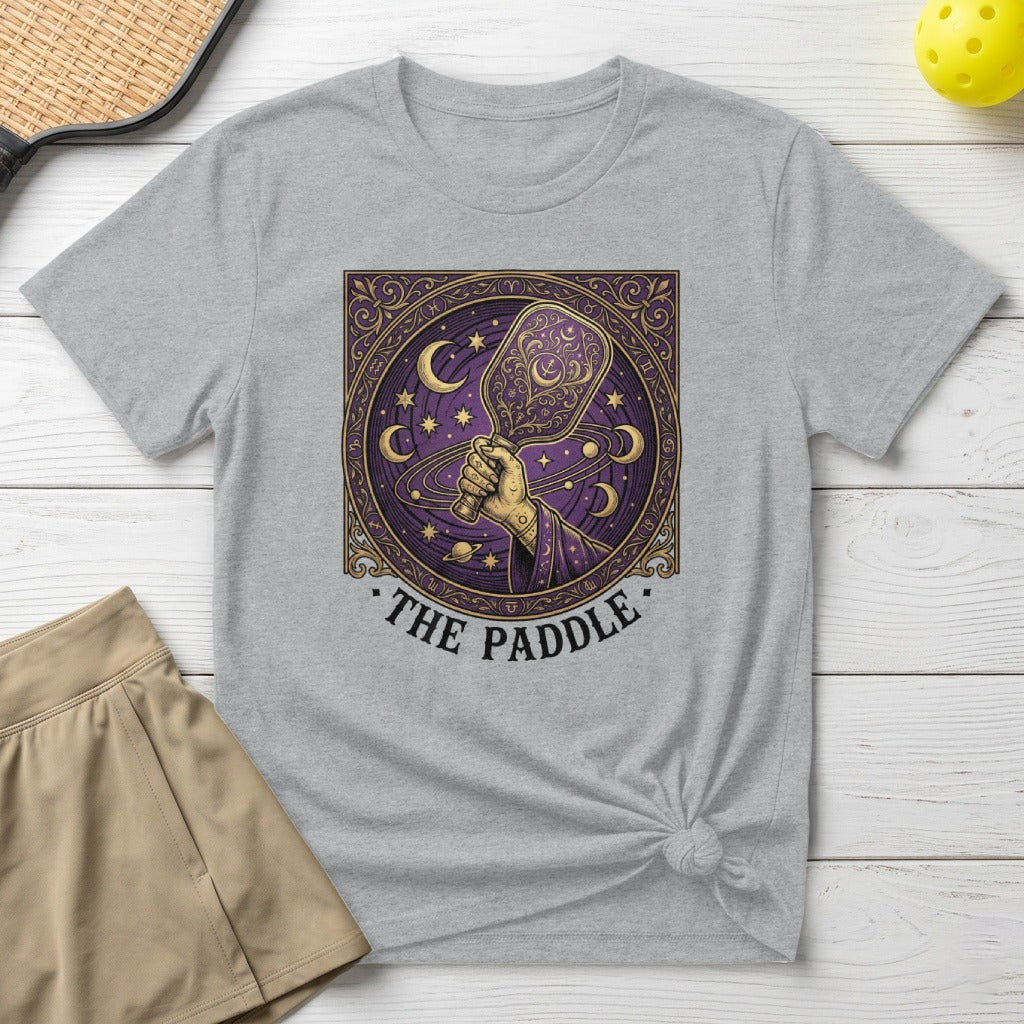 Graphic tee with celestial pickleball paddle design and text "THE PADDLE".
