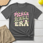 Dark grey t-shirt with "Pickle Ball Era" text and heart accents.