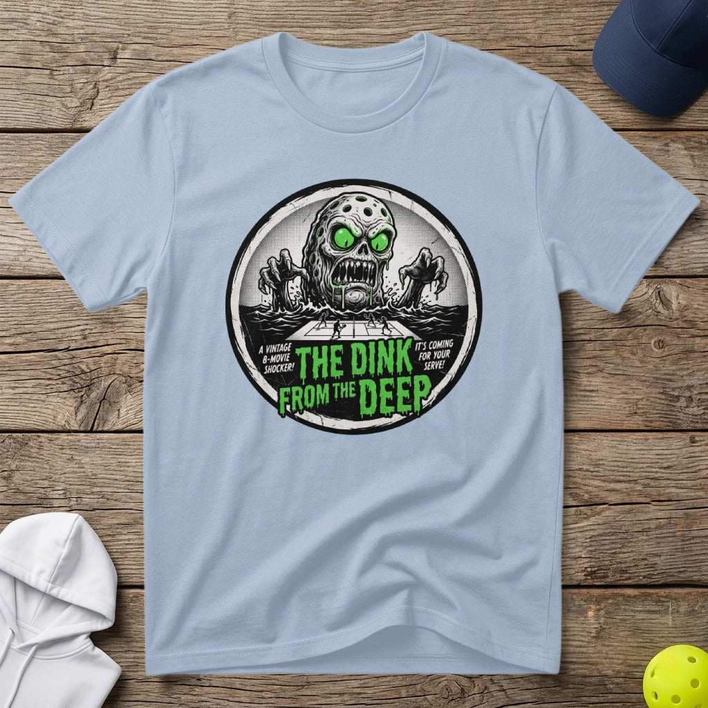 Green skull with glowing eyes emerging from water, "The Dink From The Deep" text.