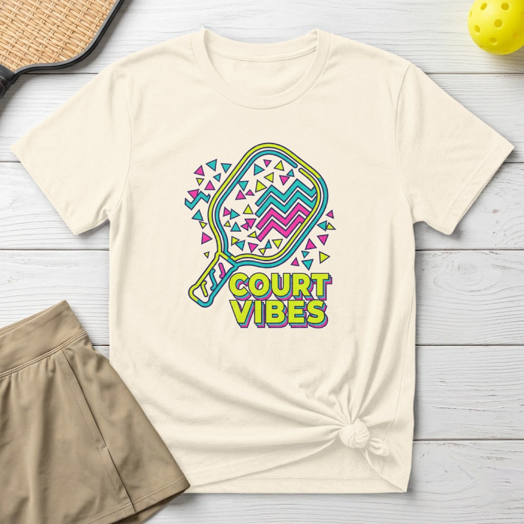Cream t-shirt with "Court Vibes" text and colorful pickleball graphic.