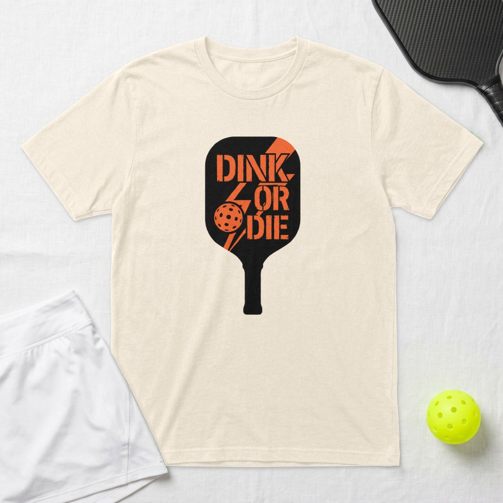 Cream t-shirt with "Dink or Die" text and pickleball paddle graphic.