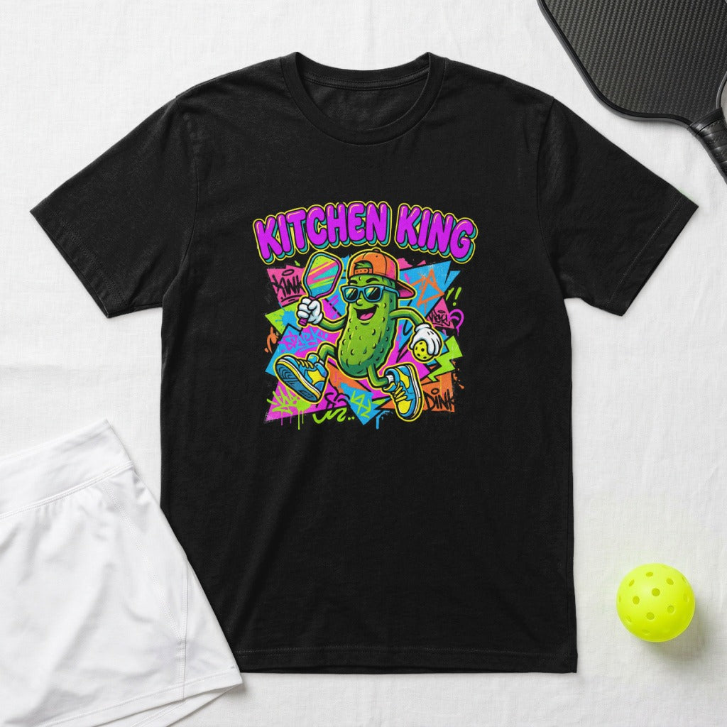 T-shirt with cartoon pickle playing pickleball, text KITCHEN KING.