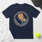 Navy t-shirt with circular pickleball graphic and text "PICKLEBALL IS CALLING ME".